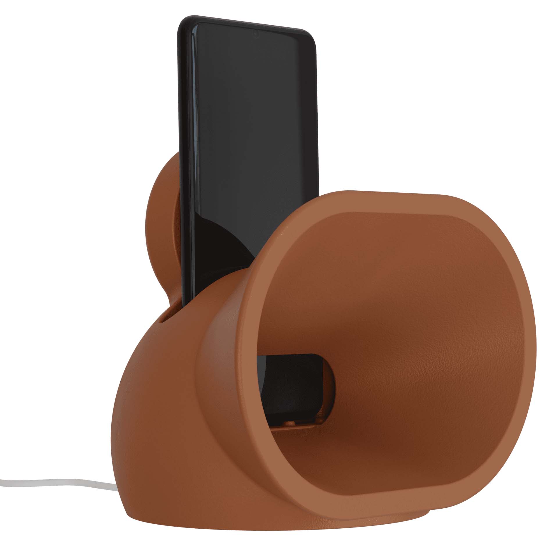 Amplificador acústico portátil, projetado para smartphones, com um design moderno e funcional. Feito de resina durável, ele utiliza uma estrutura em formato de corneta para amplificar o som do aparelho de forma natural, sem a necessidade de energia elétrica ou baterias. Seu design compacto e minimalista, na cor terracota, combina estilo e praticidade, sendo ideal para uso em ambientes internos ou externos. Além de amplificar o som, também funciona como carregador por indução.
